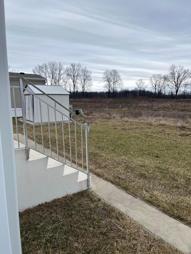 view of yard with a rural view