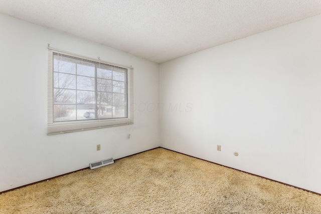 unfurnished room featuring a textured ceiling