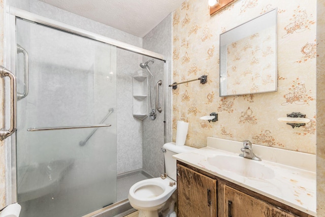 bathroom with vanity, a textured ceiling, and walk in shower