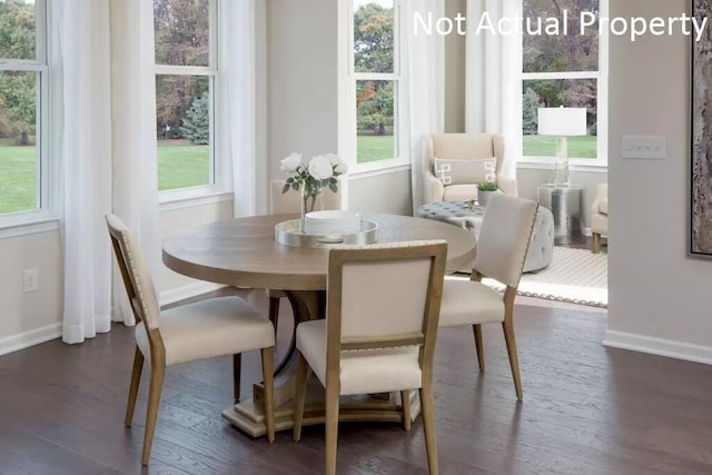 dining space with a healthy amount of sunlight and dark hardwood / wood-style floors