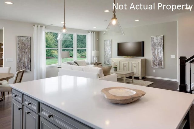 kitchen with pendant lighting, gray cabinets, and dark wood-type flooring