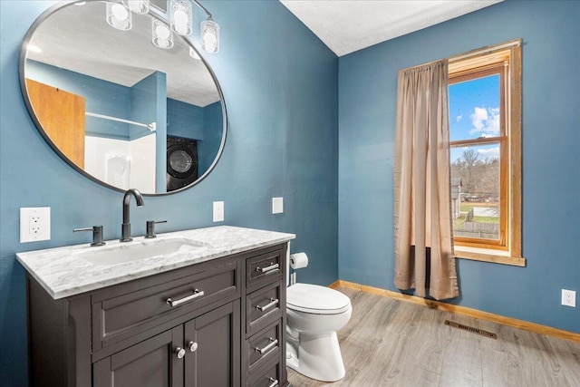 bathroom featuring walk in shower, wood-type flooring, toilet, and vanity