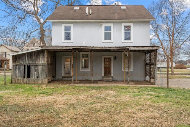 back of property featuring a lawn