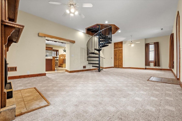 unfurnished living room with light carpet and ceiling fan