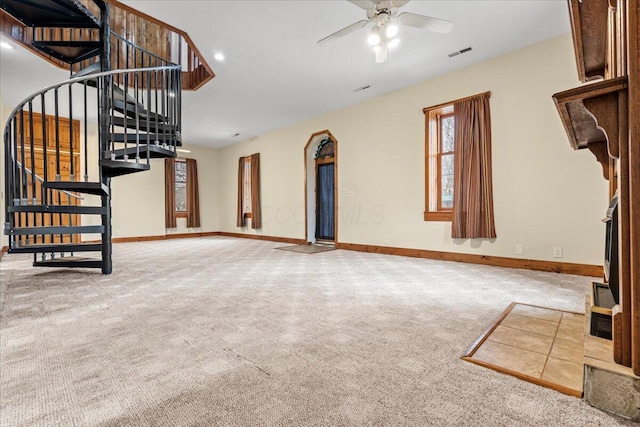 unfurnished living room featuring ceiling fan and carpet flooring