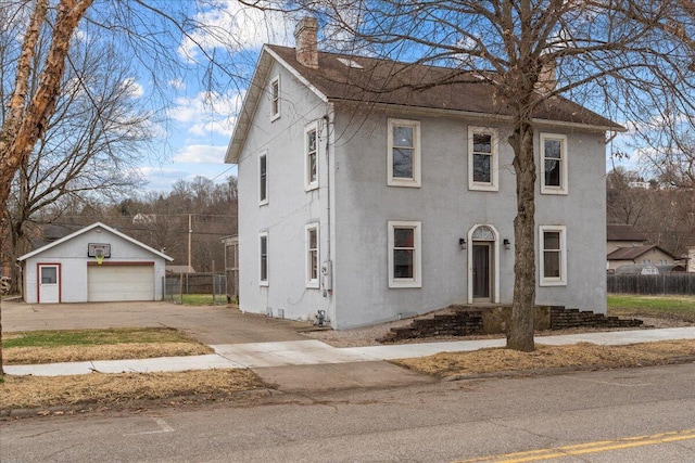 view of front of property featuring a garage and an outdoor structure