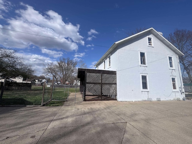 117 Franklin St, Marietta, OH 45750 - view of property exterior with fence, a gate, and stucco siding