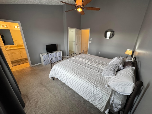 carpeted bedroom featuring ceiling fan, connected bathroom, and high vaulted ceiling