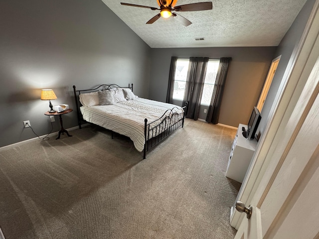 carpeted bedroom featuring vaulted ceiling, ceiling fan, and a textured ceiling