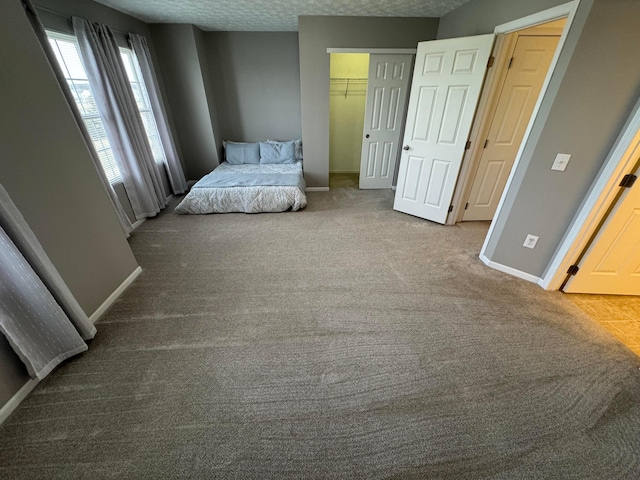 bedroom featuring carpet, a textured ceiling, and a closet