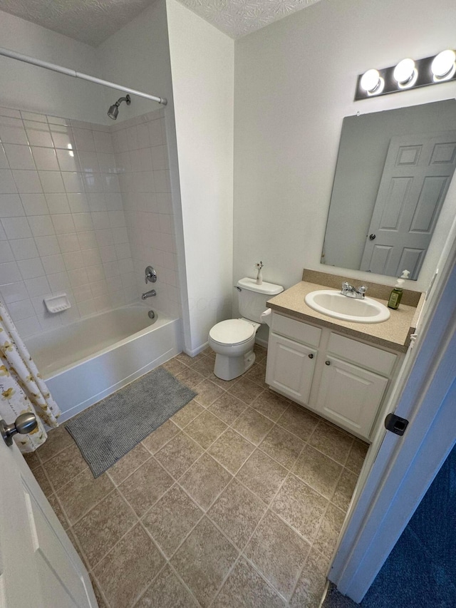 full bathroom featuring tiled shower / bath combo, vanity, tile patterned flooring, toilet, and a textured ceiling