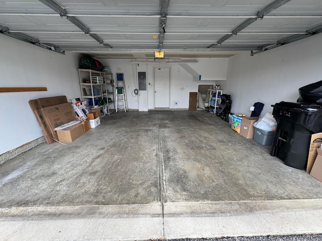 garage with a garage door opener and electric panel