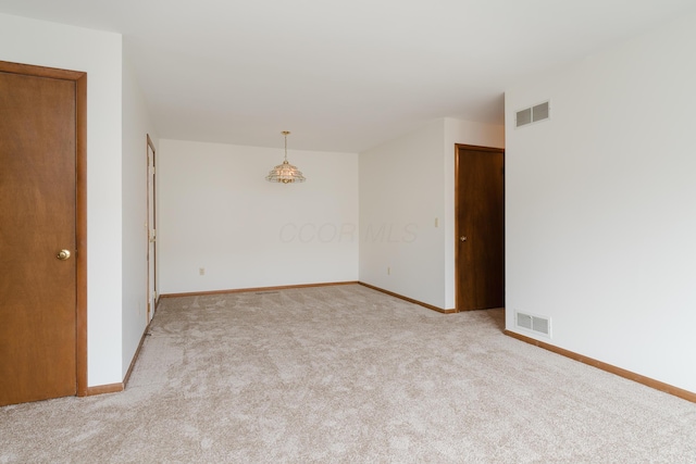 empty room featuring light carpet