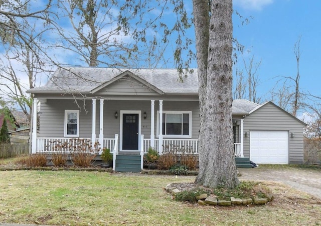 view of front of house featuring a garage, a porch, and a front lawn