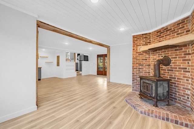 unfurnished living room featuring crown molding, light hardwood / wood-style floors, wooden ceiling, and a wood stove