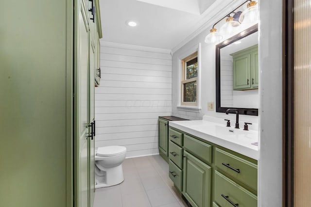 bathroom with crown molding, wooden walls, vanity, and toilet