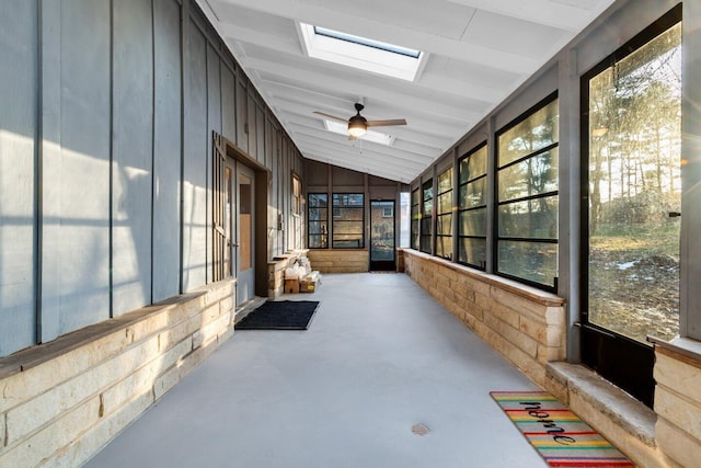 sunroom with vaulted ceiling with skylight and ceiling fan