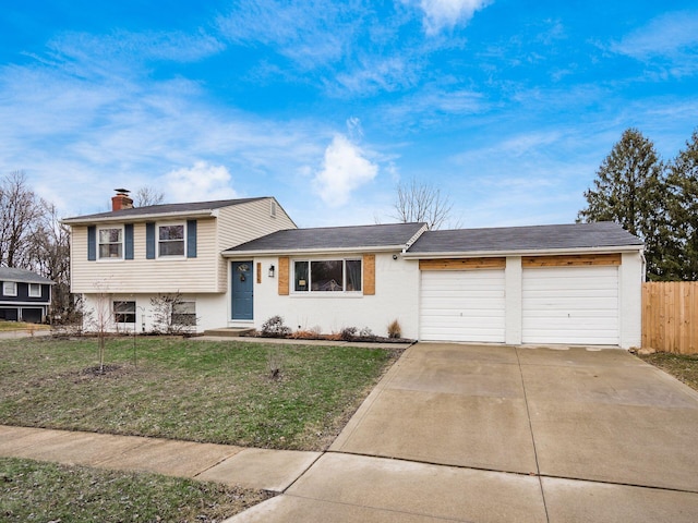 split level home featuring a garage and a front yard