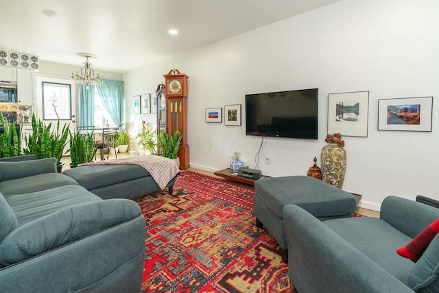 living room featuring wood-type flooring and a notable chandelier