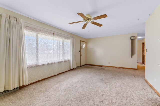 spare room with carpet floors and ceiling fan