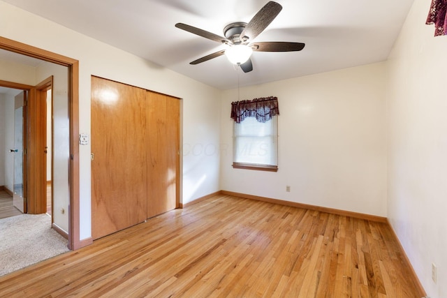 unfurnished bedroom with ceiling fan, a closet, and light wood-type flooring