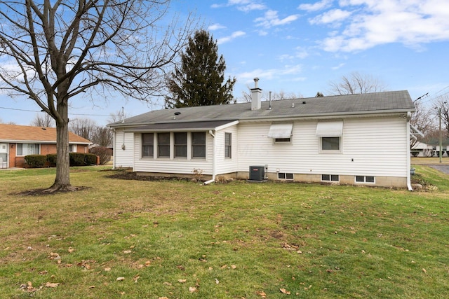 back of house featuring cooling unit and a yard