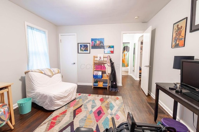 bedroom with dark wood-type flooring