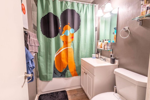 full bathroom featuring hardwood / wood-style flooring, toilet, vanity, and shower / bath combo with shower curtain