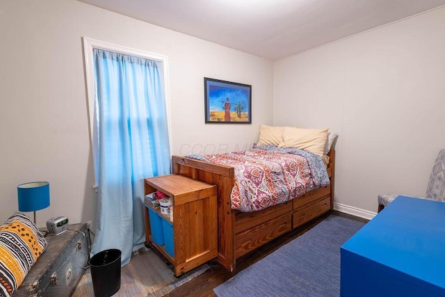 bedroom with dark hardwood / wood-style floors