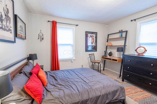 bedroom with light carpet and a textured ceiling