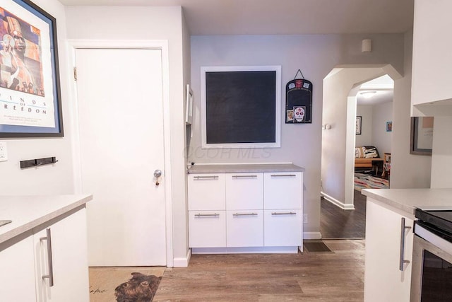 kitchen featuring white cabinetry and light hardwood / wood-style flooring