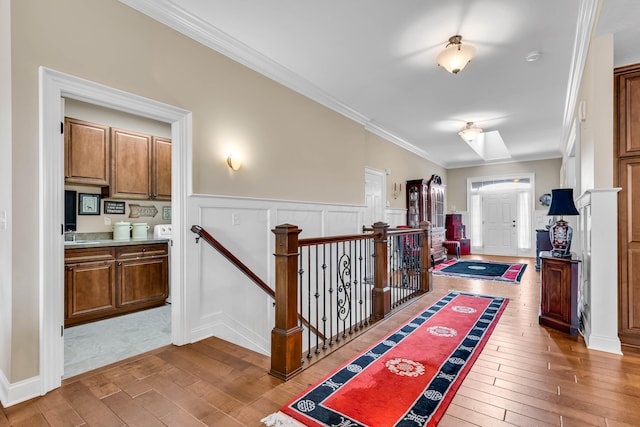 hall with ornamental molding and hardwood / wood-style floors