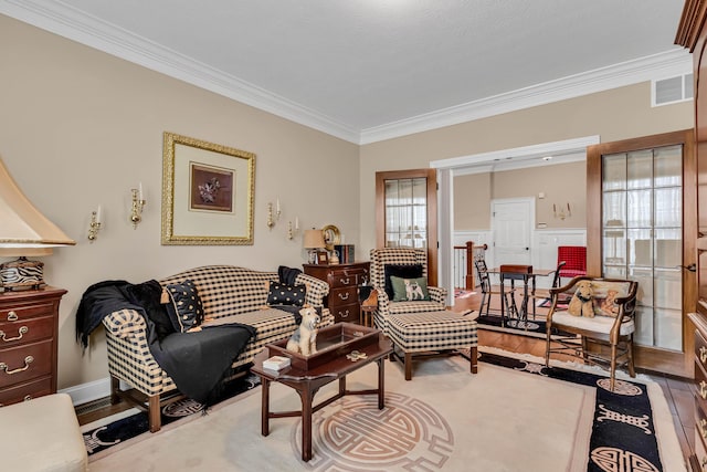 living room featuring crown molding and hardwood / wood-style flooring