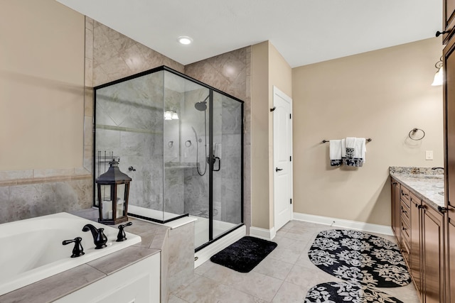 bathroom with shower with separate bathtub and vanity