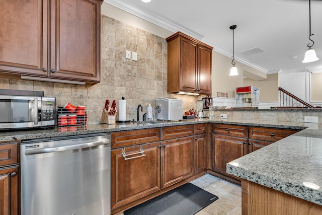 kitchen with crown molding, hanging light fixtures, appliances with stainless steel finishes, light stone countertops, and backsplash