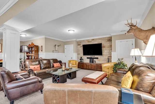 carpeted living room featuring decorative columns and crown molding