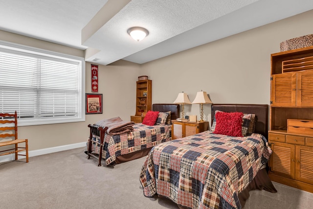 bedroom with carpet and a textured ceiling