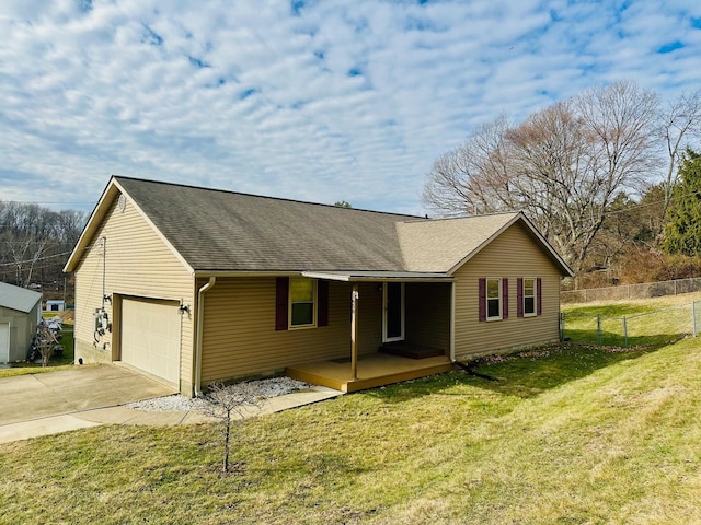 view of front of home with a garage, covered porch, and a front yard