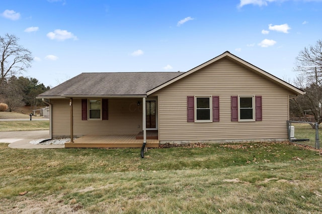 view of front facade featuring a wooden deck and a front yard