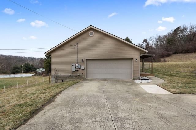 view of side of property with a garage and a lawn