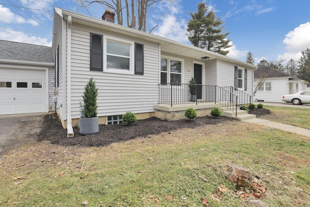 view of front of house featuring a garage and a front lawn