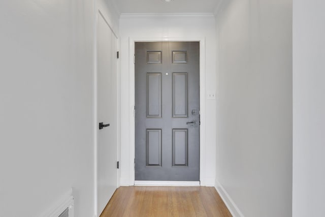 doorway featuring light hardwood / wood-style flooring and ornamental molding