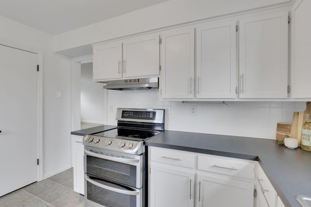 kitchen featuring double oven range, white cabinets, and decorative backsplash