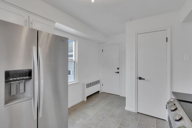 kitchen featuring white cabinetry, stainless steel refrigerator with ice dispenser, radiator, and range