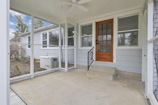 unfurnished sunroom featuring ceiling fan