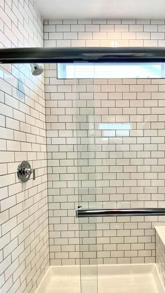 bathroom featuring a shower with shower door