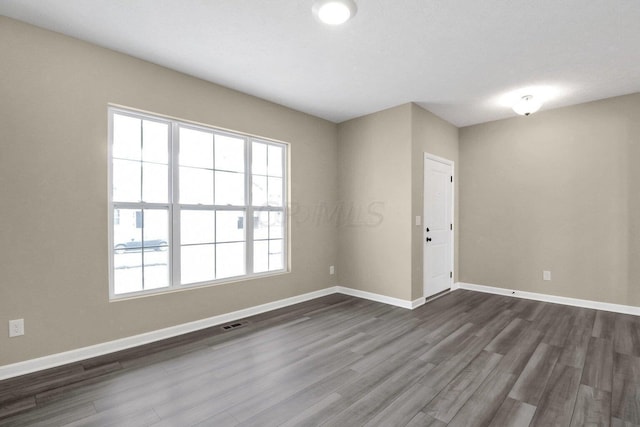 unfurnished room featuring dark hardwood / wood-style floors