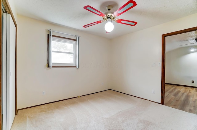 unfurnished bedroom with light colored carpet and a textured ceiling