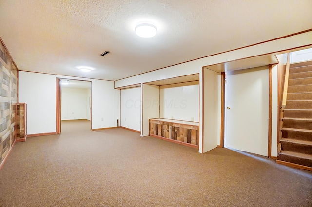 basement with carpet floors and a textured ceiling