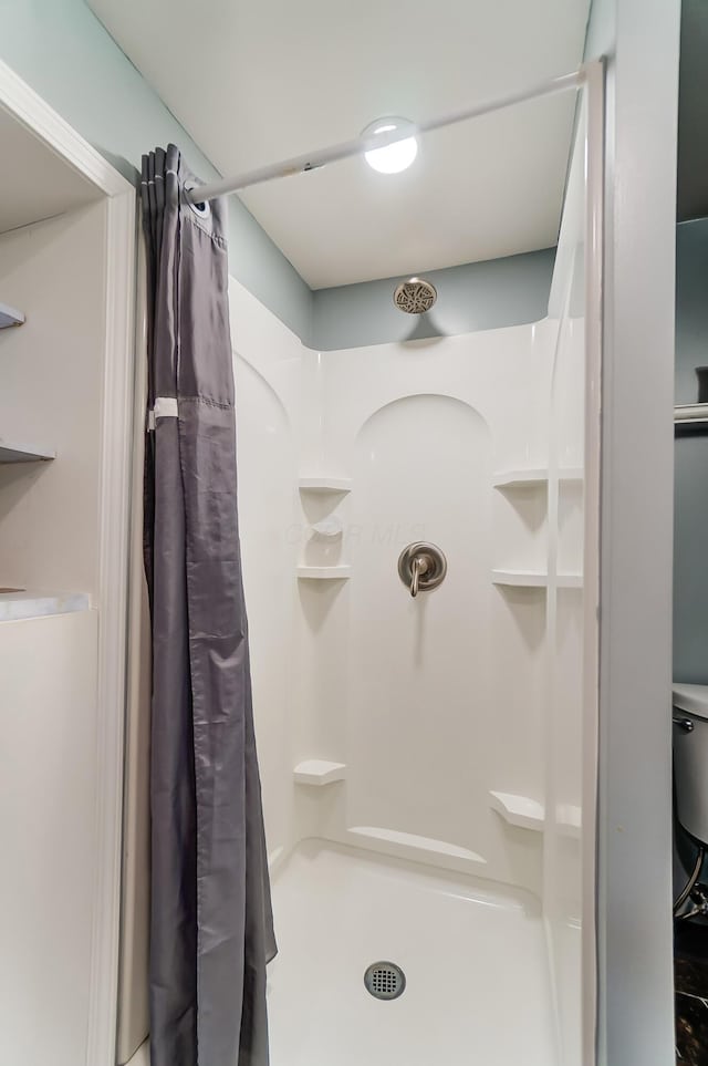 bathroom with a shower with shower curtain